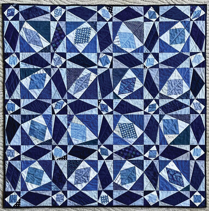 Quilt with blue and white geometric pattern