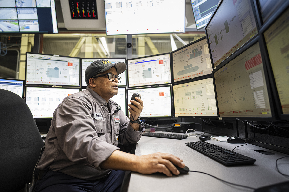 Bhulai speaks into a radio while monitoring numerous computer monitors