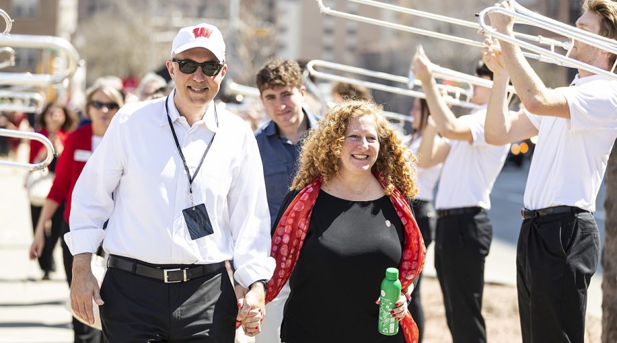 Chancellor Mnookin (right) walks with her husband Joshua Foa Dienstag during a procession from the Hamel Music Center to a post-Investiture ceremony picnic on Library Mall at the University of Wisconsin–Madison on April 14, 2023. The picnic included live music, entertainment, free food, and the inaugural serving of Chancellor Mnookin’s ice cream flavor (Mnookie Dough). The event is part of Investiture Week, a series of special campus events planned for April 10-15 to celebrate the university and formally welcome Mnookin as chancellor. (Photo by Taylor Wolfram / UW–Madison)