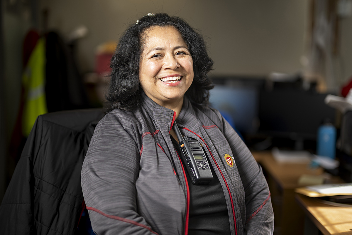 Guadalupe Jensen sits at desk and smiles