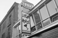 Grayscale photo of the exterior of Troia's Steak House.