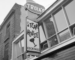 Grayscale photo of the exterior of Troia's Steak House.