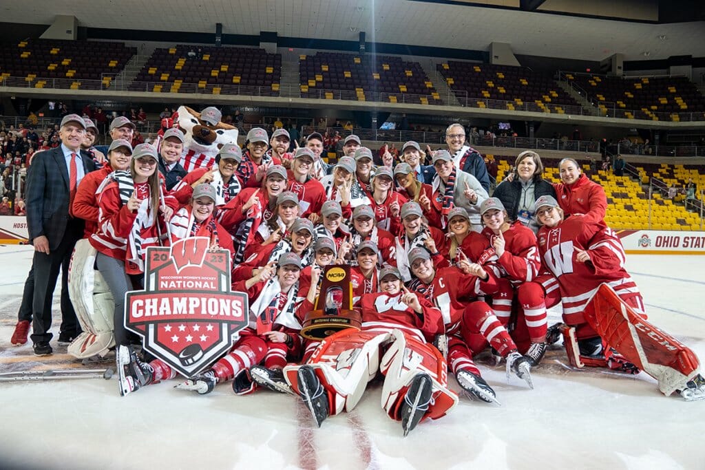 The Wisconsin Women's Hockey team poses for a team photo together on the ice after winning the 2023 NCAA Women's Ice Hockey National Championships at AMSOIL Arean in Duluth, Minnesota.