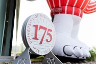 UW–Madison 175th emblem next to the clawed feet of a Bucky Badger statue