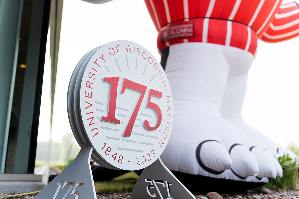 UW–Madison 175th emblem next to the clawed feet of a Bucky Badger statue