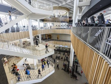 Central interior area of the new Bakke recreation center showing patrons traversing staircases leading to multiple levels