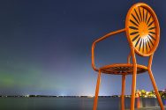 Orange Terrace chair against night sky over Lake Mendota