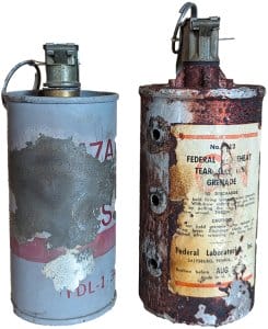 Two old and damaged tear gas canisters.