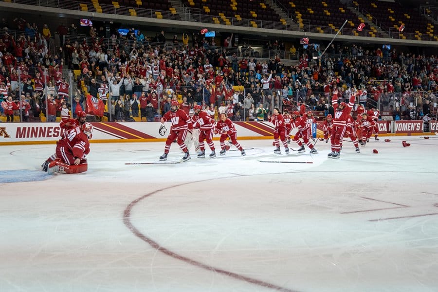 The women's hockey team celebrates and hugs in the final moment of the national championship game.