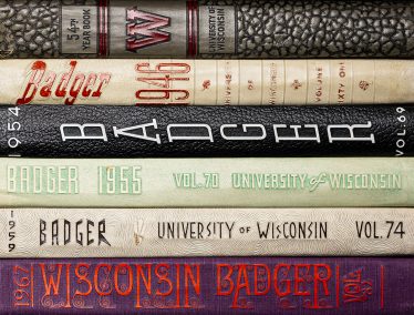 A stack of Badger Yearbooks from the 1900s.