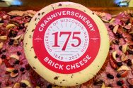 A brick cheese made by Babcock Dairy to celebrate Wisconsin's 175th anniversary called Cranniverscherry.