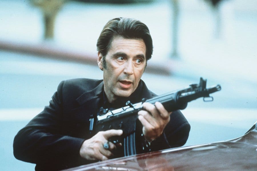 Still frame of actor Al Pacino holding a machine gun.