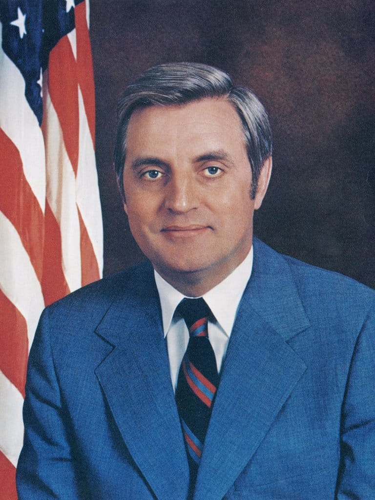 Walter Mondale's vice presidential portrait shows Mondale in a blue suit in front of an American flag.