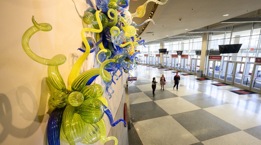 colorful Chihuly glass sculptures line a wall in the Kohl Center