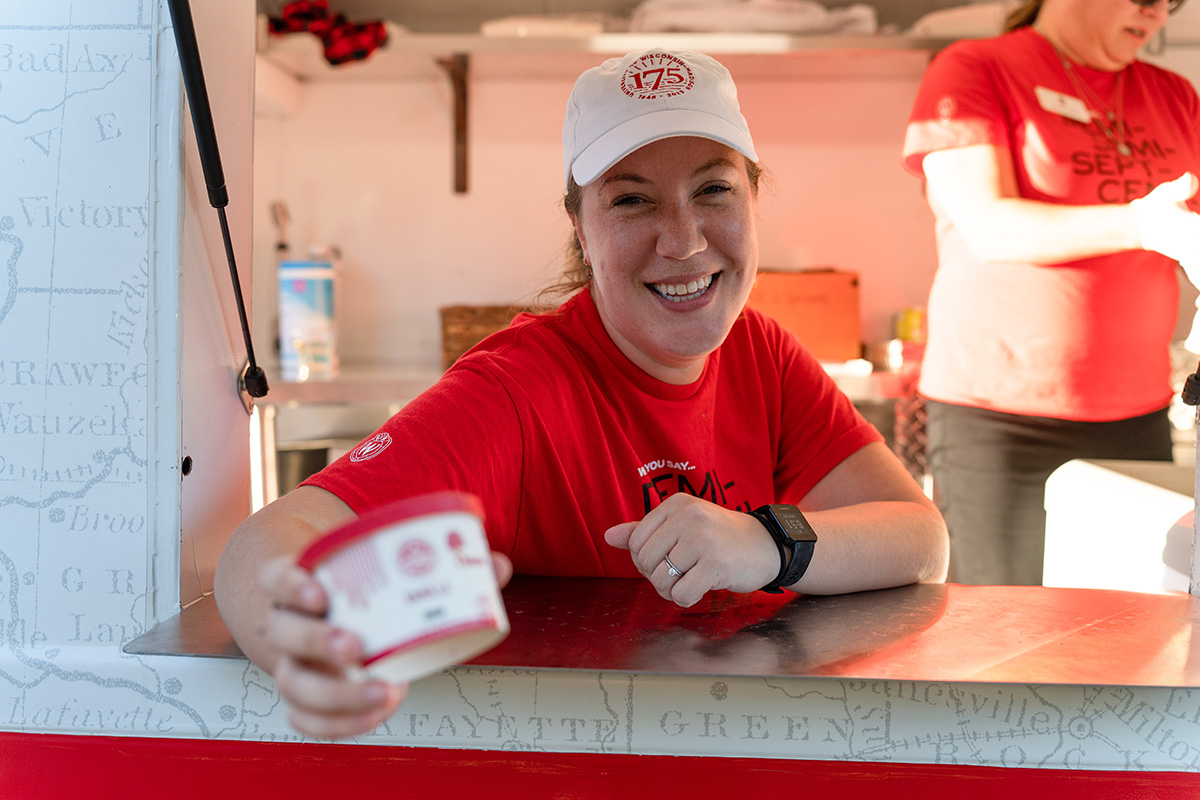 A woman offers a single-serve ice cream from the 175 ice cream truck.