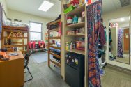 A dorm room in the new Leopold residence hall with loft beds and a walk-in closet