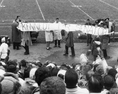 Black and white photo of people holding a large banner in front of a crowd that reads "Kennedy for Senator"