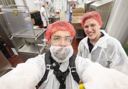 Richter and Schmitt pose for a selfie wearing sanitary protective gear