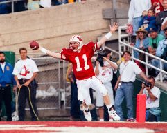 Darrell Bevell in his Badger football uniform making a touchdown on the football field.