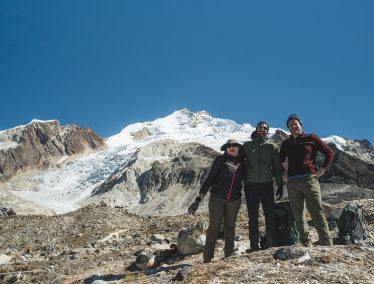 Yasmeen Orellana Salazar, Matias Romero, and Andy Jones pose in front of the Zongo Glacier