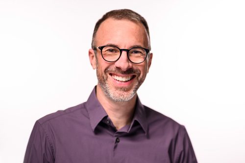 Headshot of Barry Burden, smiling and wearing a purple button-up shirt.