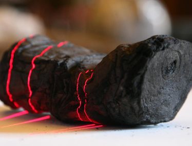 A lump of char in the vague shape of a scroll during the scanning process.