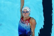 Close-up image of Phoebe Bacon swimming backstroke, and wearing a USA technical suit.