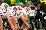 The Badgers' offensive line prepares to snap the ball while playing against the Oregon Ducks.