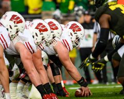 The Badgers' offensive line prepares to snap the ball while playing against the Oregon Ducks.