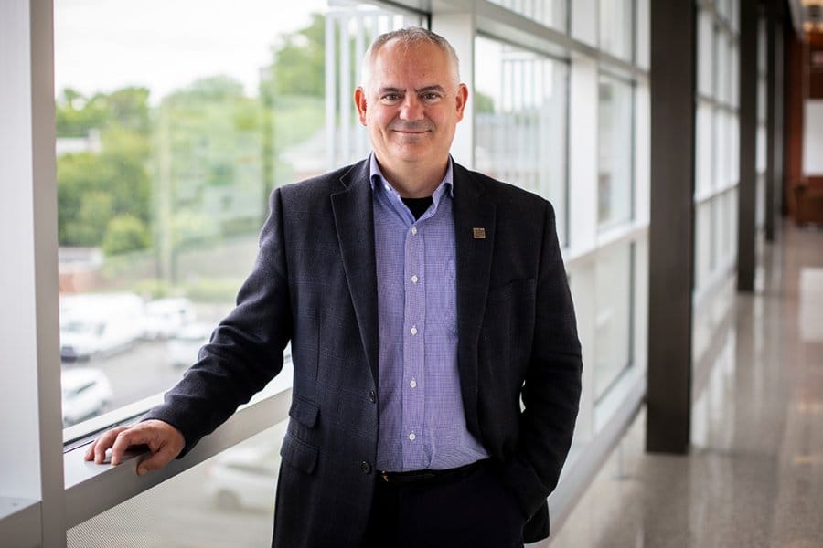 Seales poses in a suit and tie, near a window.