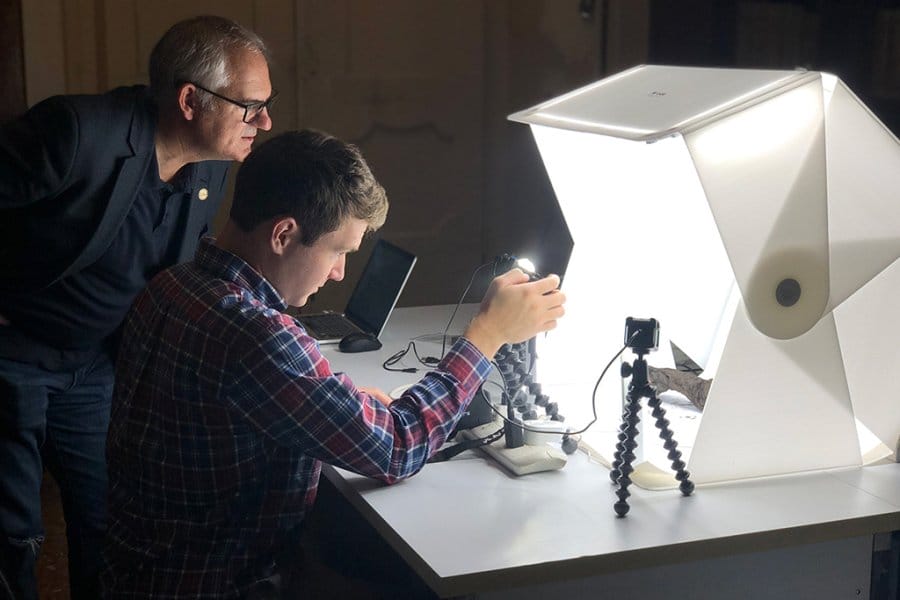 Seales and student Stephen Parsons carefully capture imagery of a Herculaneum scroll.