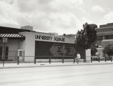 Black and white photo of the old University Square Building on campus, next to Vilas Hall.