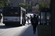 Students board the route 80 bus at a stop