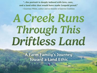 Book cover of 'A Creek Runs Through This Driftless Land' by Richard L. Cates Jr., featuring a scenic aerial view of a lush, green landscape with winding paths and a creek.