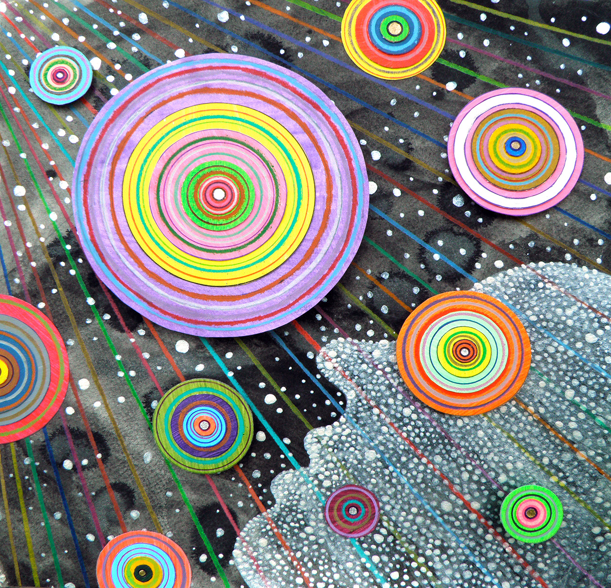 Colorful, abstract artwork featuring concentric circles of various sizes and colors against a dark background with white dots and multicolored lines, resembling a cosmic or galactic scene.