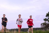 Rowen Ellensberg, Christian deVaal, and Bob Liking, members of the men’s cross country team, run in Curtis Prairie on a summer evening at the UW Arboretum at the University of Wisconsin–Madison