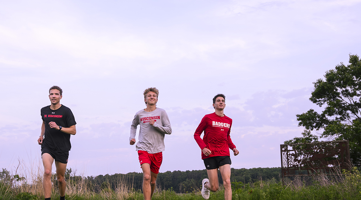 Rowen Ellensberg, Christian deVaal, and Bob Liking, members of the men’s cross country team, run in Curtis Prairie on a summer evening at the UW Arboretum at the University of Wisconsin–Madison