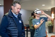 Mike Grall of Fulcrum Cybersecurity watches Tech Exploration Lab participant Mason Baloun, founder of PEAR (Piano Education in Augmented Reality), use his Meta Quest during the Tech Exploration Lab