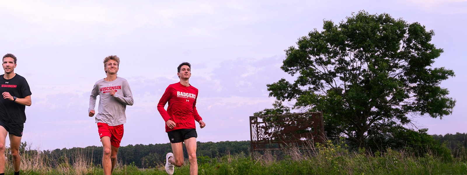 Rowen Ellensberg, Christian deVaal, and Bob Liking, members of the men’s cross country team, run in Curtis Prairie on a summer evening at the UW Arboretum at the University of Wisconsin–Madison