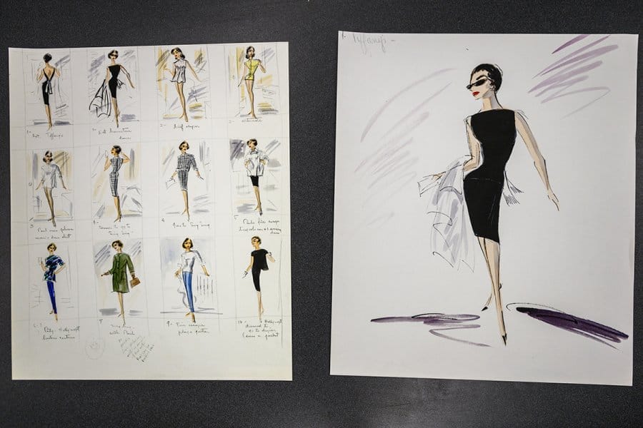 Fashion sketches from the costume archive for 'Breakfast at Tiffany's', featuring a black dress and twelve smaller outfit designs including dresses, suits, and casual wear.
