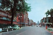 A vintage street scene of State Street with storefronts including 'Rennebohm' and the state capitol building in the background.