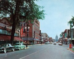 A vintage street scene of State Street with storefronts including 'Rennebohm' and the state capitol building in the background.