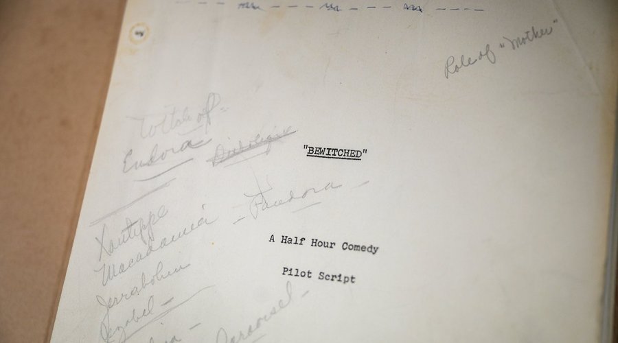 A close-up of the pilot script cover page for the TV show 'Bewitched,' displaying handwritten notes and character names including Endora, Darrin, and Samantha.
