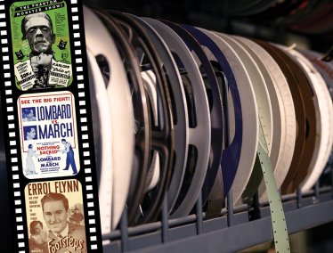 A shelf filled with colorful archival film reels, some with hanging strips.