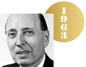 Black and white headshot of Eugene (E.P.) Wigner with an overlapping gold circle representing a Nobel medal, with the year 1963 on it.