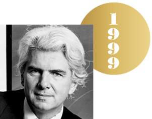 Black and white headshot of Günter Blobel with an overlapping gold circle representing a Nobel medal, with the year 1999 on it.