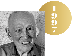 Black and white headshot of Paul Boyer with an overlapping gold circle representing a Nobel medal, with the year 1997 on it.