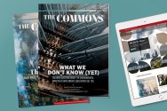 Two print copies of 'The Commons' magazine are layered next to a tablet displaying the publication's digital edition.