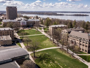 An aerial view of Bascom Hill and surrounding campus buildings overlooking Lake Mendota.