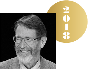 Black and white headshot of George P. Smith with an overlapping gold circle representing a Nobel medal, with the year 2018 on it.